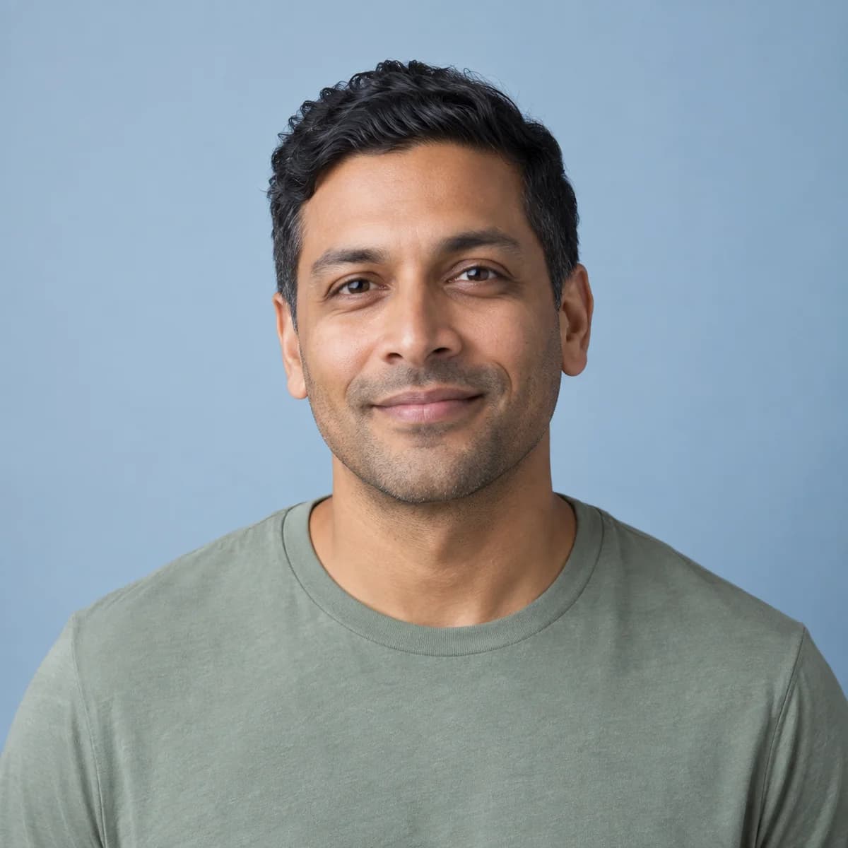Studio portrait of an adult man on a slate background